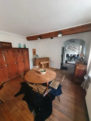 a dining room with a wooden table and chairs at Très belle maison chaleureuse au coeur de Mirepoix in Mirepoix