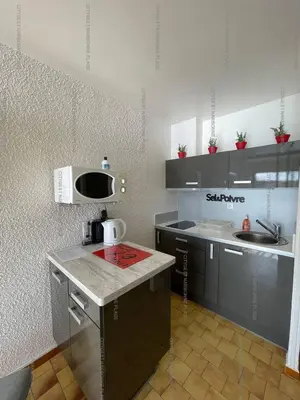 a small kitchen with a counter and a microwave at Idéal couple avec vue sur le PORT DE GRUISSAN 4CHE24 in Gruissan