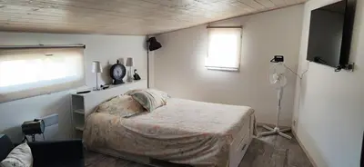 a small bedroom with a bed and a window at La maisonnette du jardin Narbonne in Narbonne