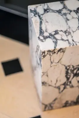 a close up of a marble counter top with a table at Hôtel Le Mosaïque in Narbonne