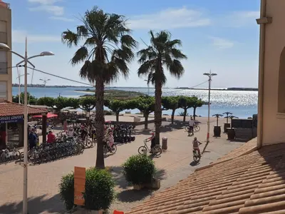 a group of people riding bikes on the beach at Appartement GRUISSAN Plage du Grazel in Gruissan