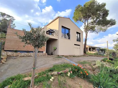 a house with a tree in a yard at VILLA ENTIERE BELLEVUE - Balnéo - Piscine - Clim in Montséret
