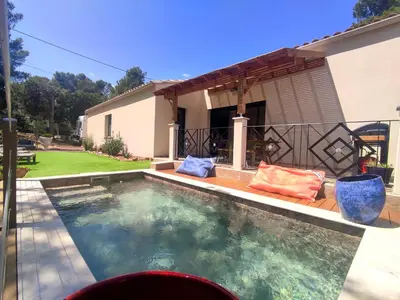 a swimming pool in front of a house at VILLA ENTIERE BELLEVUE - Balnéo - Piscine - Clim in Montséret
