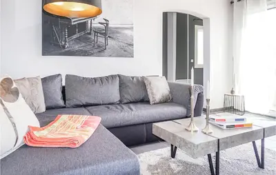 a living room with a gray couch and a table at Lovely Home In Cruzy With Kitchen in Cruzy