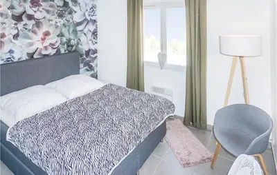 a bedroom with a bed and a chair and a window at Lovely Home In Cruzy With Kitchen in Cruzy