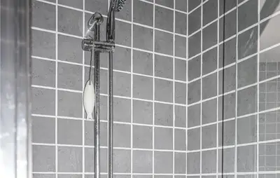 a shower in a bathroom with gray tiles at Lovely Home In Cruzy With Kitchen in Cruzy