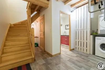 a laundry room with a staircase and a washing machine at Les gites du Canal du Midi - Gîte La Cordonnerie in Renneville