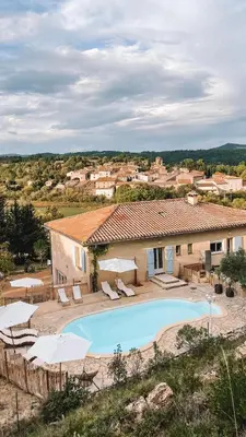 a villa with a swimming pool and a house at NOUS in Agel
