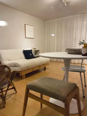a room with a bed and a table and chairs at NOUS in Agel