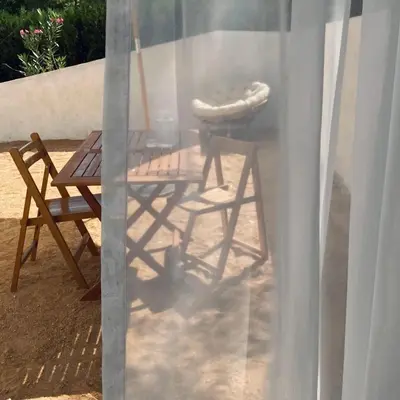 a tent with a chair and a chair at NOUS in Agel