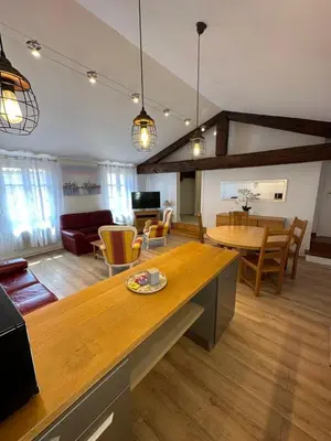 a kitchen and living room with a table and chairs at Maison du Cloitre Couvent des Carmes in Narbonne