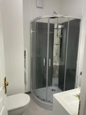 a bathroom with a glass shower and a toilet at Maison du Cloitre Couvent des Carmes in Narbonne