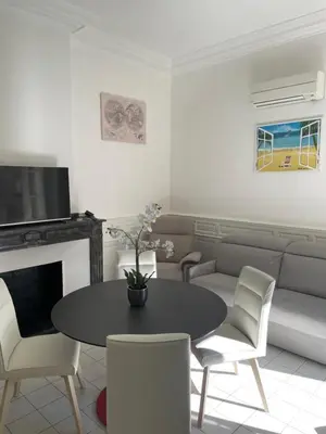 a living room with a table and chairs and a couch at Maison du Cloitre Couvent des Carmes in Narbonne
