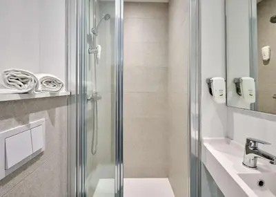 a bathroom with a shower and a sink at Kyriad ECO - Narbonne Sud in Narbonne