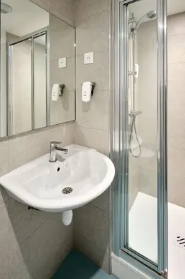 a bathroom with a sink and a shower at Kyriad ECO - Narbonne Sud in Narbonne