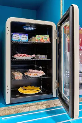 an open refrigerator with food inside of it at Kyriad ECO - Narbonne Sud in Narbonne
