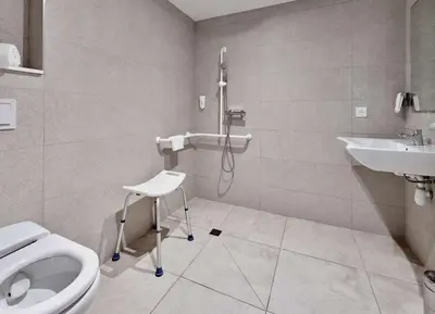 a bathroom with a shower and a toilet and a sink at Kyriad ECO - Narbonne Sud in Narbonne