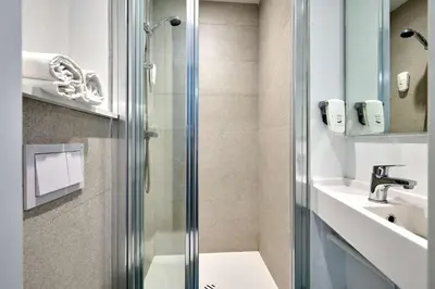 a bathroom with a shower and a sink at Kyriad ECO - Narbonne Sud in Narbonne
