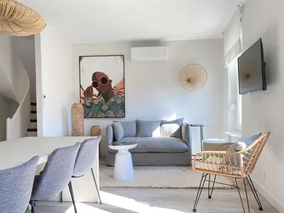 a living room with a table and a couch at La Terrasse sur les Toits in Narbonne