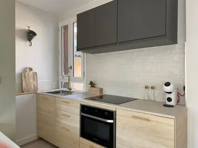 a kitchen with a sink and a stove top oven at La Terrasse sur les Toits in Narbonne