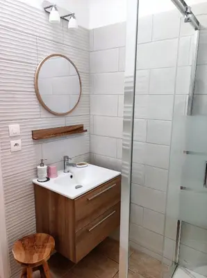 a bathroom with a sink and a mirror at La Villa Carcassonne, Chambres d hôtes, B&B, face à la Cité Médiévale in Carcassonne