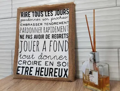 a sign sitting on a table next to a vase at La Villa Carcassonne, Chambres d hôtes, B&B, face à la Cité Médiévale in Carcassonne