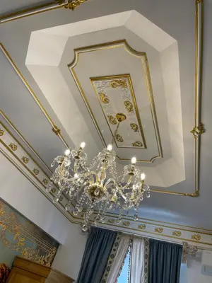 a chandelier hanging from a ceiling in a room at Chambre Familiale Maison de L'Église du Couvent in Narbonne