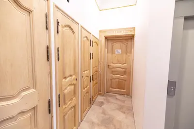 a hallway with wooden cabinets and a door at Chambre Familiale Maison de L'Église du Couvent in Narbonne