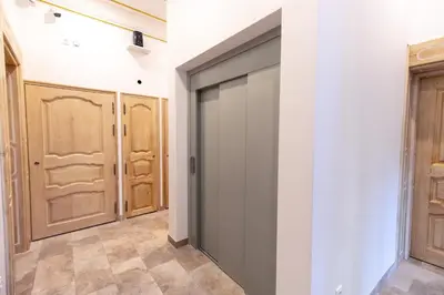 a sliding door in a hallway with wooden doors at Chambre Familiale Maison de L'Église du Couvent in Narbonne