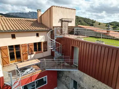 a building with a staircase on the side of it at MAURY CAT'STUDIO 66 in Maury