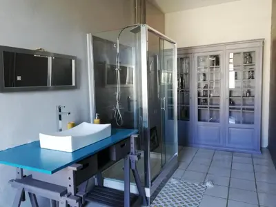 a bathroom with a sink and a shower at Le Clos'art in Vinassan