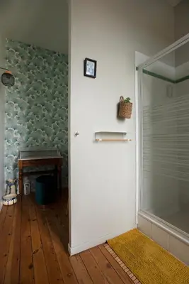a bathroom with a shower and a glass door at Le Clos'art in Vinassan