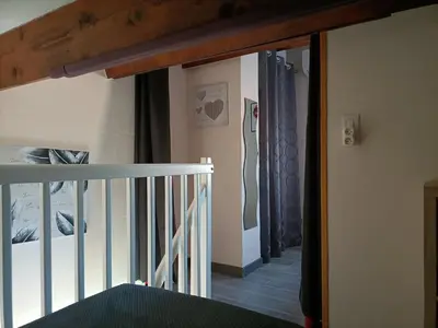 a stairway leading to a room with a stair railing at L'Appart de Karine et Nico in Gruissan