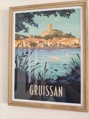 a framed picture of a painting of a city at L'Appart de Karine et Nico in Gruissan