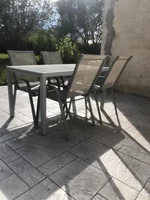a table and chairs sitting on a patio at Gîte la Lezardière accès privé canal du midi ** in Castelnaudary