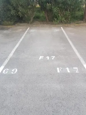 an empty parking lot with the word parking written on it at studio gruissan proche plage des chalets in Gruissan