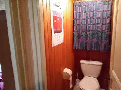 a bathroom with a toilet and a shower curtain at LA BOULZANE in Puilaurens