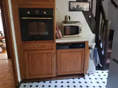 a kitchen with a stove and a microwave at LA BOULZANE in Puilaurens