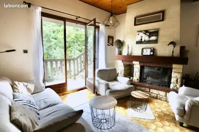 a living room with a couch and a fireplace at LA BOULZANE in Puilaurens