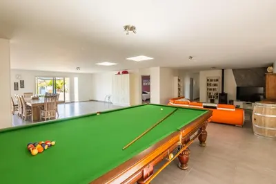 a living room with a pool table in it at Villa avec piscine et Jaccuzy in Bize-Minervois