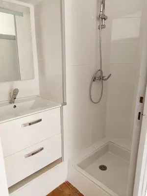 a white bathroom with a sink and a shower at Jolie studio récemment rénové in Marseillette