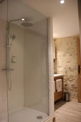 a shower with a glass door in a bathroom at Cottage - La Maison du Château - By DOMAINE RIBERACH in Bélesta