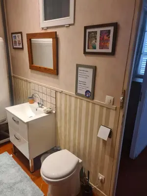 a bathroom with a toilet and a sink and a mirror at Maison Carrasserie in Limoux