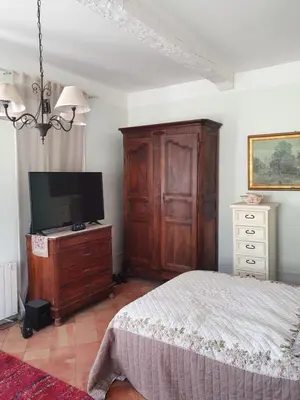 a bedroom with a bed and a tv on a dresser at Maison Carrasserie in Limoux