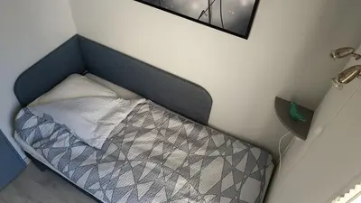 a small bed in a corner of a room at Saphir de Gruissan in Gruissan