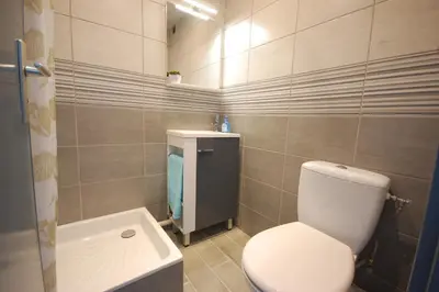 a bathroom with a white toilet and a sink at Saphir de Gruissan in Gruissan