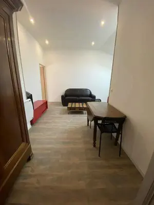 a living room with a couch and a table at Douceur occitane in Saint-Chinian