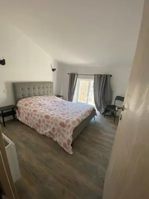 a bedroom with a bed and a large window at Douceur occitane in Saint-Chinian