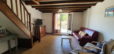 a living room with a couch and a tv at L'ECRIN DU LAC - L'Ortencia in Mazamet