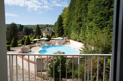 a view of a swimming pool from a balcony at L'ECRIN DU LAC - L'Ortencia in Mazamet